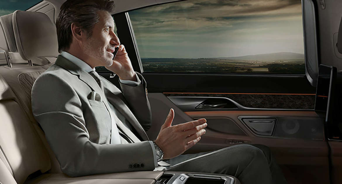 Business traveller in the back seat of a G4 Cars executive vehicle